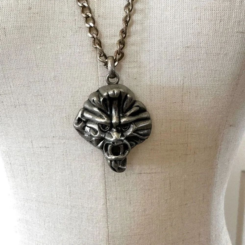 Silver tone face pendant necklace